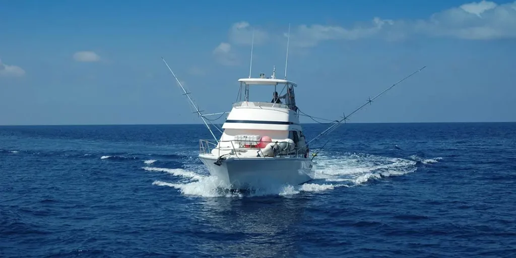 Sport fishing charter boat heading offshore in South Florida ocean waters